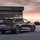 Audi S5 Avant (2024): rear three quarter static, modern house in background, grey paint