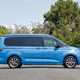 Image of a static, blue Volkswagen California, viewed from the right side