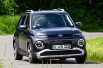 Hyundai Inster review, black, exterior, moving, front three quarters | Parkers