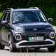 Hyundai Inster review, black, exterior, moving, front three quarters | Parkers