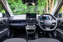 Hyundai Inster review, black, interior, dashboard, steering wheel | Parkers