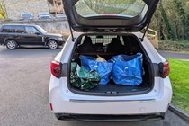 Image of Toyota Corolla Commercial loaded with bags of junk