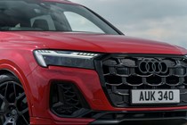 Audi Q7 (2025) review: LED headlight and radiator grille detail, red paint