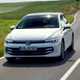 Volkswagen Golf eHybrid (2024) review: front three quarter driving, white paint