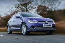 Volkswagen Polo (2024) review: front three quarter driving, British road, purple paint