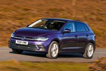 Volkswagen Polo (2024) review: front driving panning shot, British road, purple paint