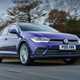 Volkswagen Polo (2024) review: front three quarter driving, British road, purple paint