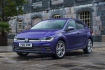Volkswagen Polo (2024) review: front three quarter static, old building in background, purple paint