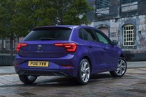 Volkswagen Polo (2024) review: rear three quarter static, old building in background, purple paint