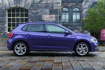 Volkswagen Polo (2024) review: side view static, old building in background, purple paint