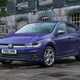 Volkswagen Polo (2024) review: front three quarter static, old building in background, purple paint