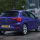 Volkswagen Polo (2024) review: rear three quarter static, old building in background, purple paint