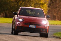 Abarth 600e (2024) review: front cornering, orange paint