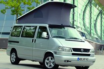 Image of Volkswagen T4 camper van in silver, front right three-quarters view with raised pop-top