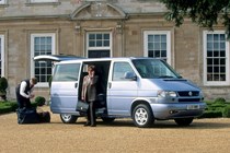 Image of Volkswagen T4 Caravelle in silver, with passenger stood by open side door