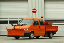 Image of Volkswagen T4 pick-up truck in orange, equipped as a snow plow and road gritter