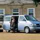 Image of Volkswagen T4 Caravelle in silver, with passenger stood by open side door