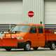 Image of Volkswagen T4 pick-up truck in orange, equipped as a snow plow and road gritter