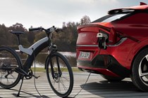 Image of a Kia EV6 plugged into an electric bike