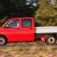 Image of the Volkswagen T5.1 double-can pickup truck, in red, viewed from the left side