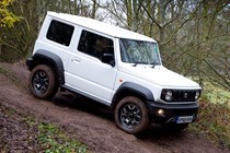 Suzuki Jimny review - side view, white, driving off-road using hill descent control