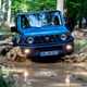 Suzuki Jimny review - front view, blue, off-road, fording muddy river