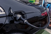 Close-up image of a black Mercedes S580e ion charge, focused on the charging port