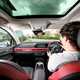 Ryan Gilmore drives the GWM Ora 03, interior shot, black, red, driving | Parkers