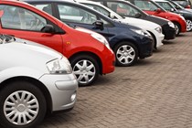 Line-up of a variety of used cars on a dealer's forecourt