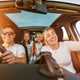 Image of a family having fun while out for a drive, shot from the car's dashboard