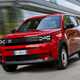 Fiat Panda (2025) review: front three quarter driving, red paint, offset angle