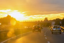 Image of traffic on a motorway under bright sunlight