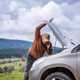 Image of a man opening the bonnet of a broken down Nissan