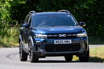 Dacia Bigster (2025) review: front three quarter driving, blue paint, low angle