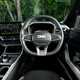Dacia Bigster (2025) review: steering wheel and driver's seat, black and grey upholstery