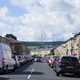 Image of cars parked on cars parked on both sides of a road in a small Lancashire town