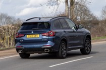 BMW X3 review (2023): rear three quarter cornering shot, blue car, rural background