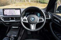 BMW X3 review (2023): drivers seat and digital gauge cluster, black upholstery