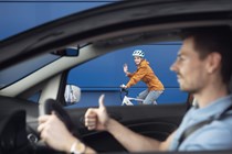 Image of a driver giving a cyclist the thumbs up while passing safely