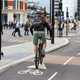 Image of a cyclists in a cycle lane approaching traffic lights