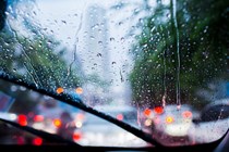 Image through the windscreen of a car driving in heavy rain