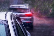 Image of a pair of cars queueing in heavy rain