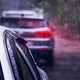 Image of a pair of cars queueing in heavy rain