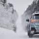 Image of a Subaru Crosstrek driving along a snowy, hilly road