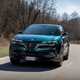 Alfa Romeo Junior Ibrida (2025) review: front three quarter cornering, blue paint