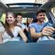 Image of four young people riding in a car