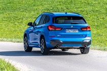 Blue 2019 BMW X1 SUV rear three-quarter driving