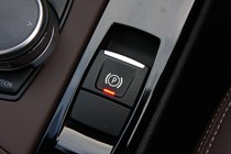 BMW 2016 X1 SUV Interior detail - electronic parking brake on/off swich