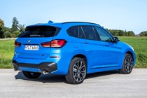 Blue 2019 BMW X1 SUV rear three-quarter driving