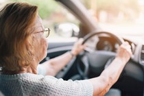 Image of an elderly woman driving a car